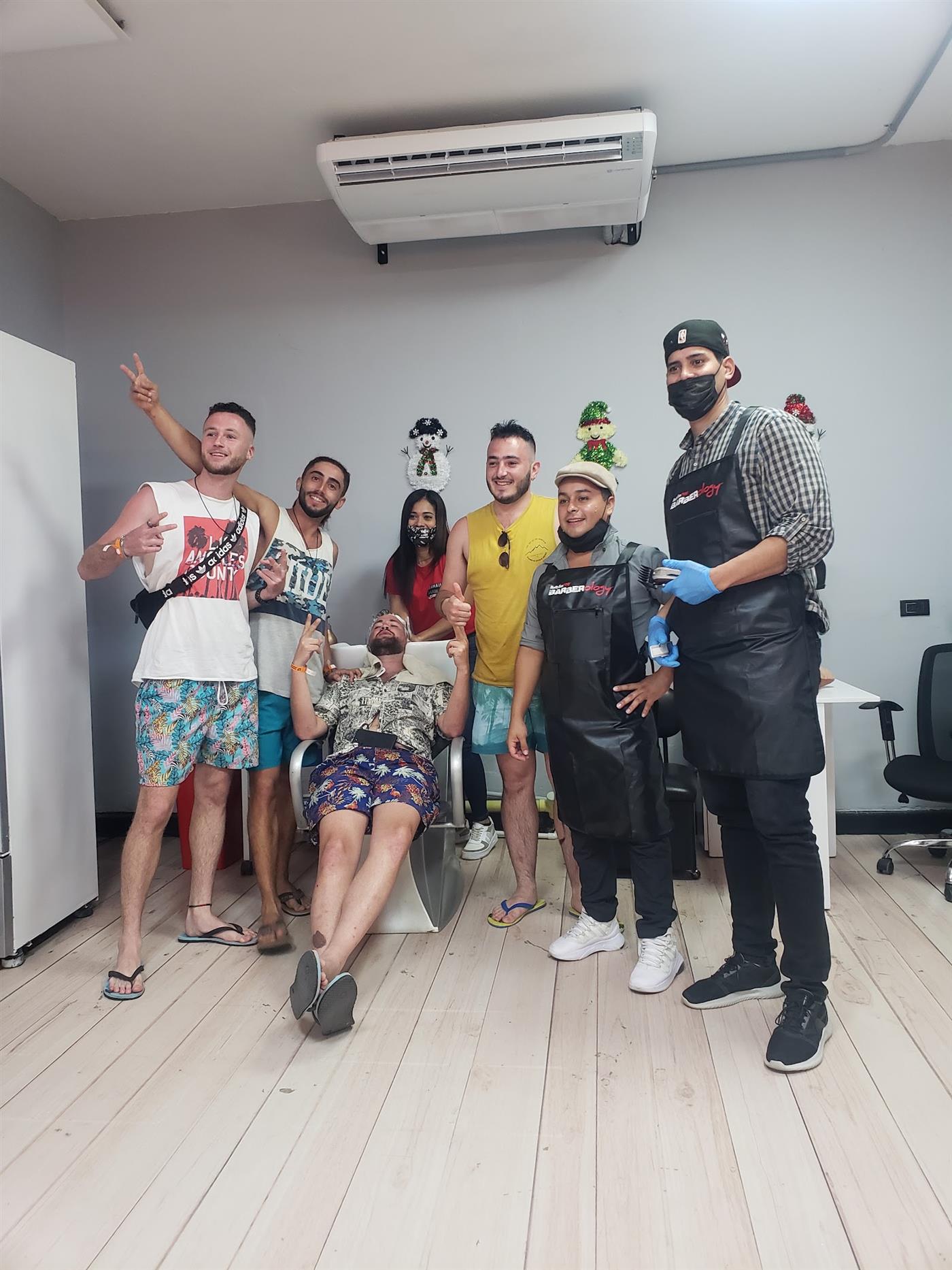 Grupo de clientes con el equipo de la barbería